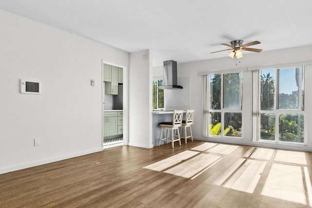 unfurnished living room featuring ceiling fan