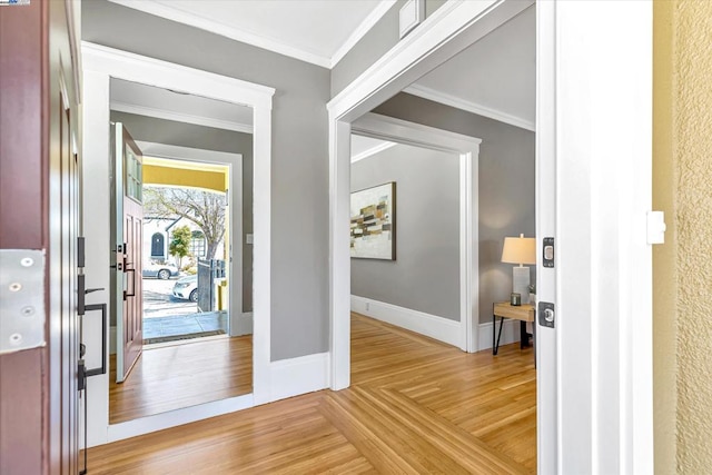 entryway with hardwood / wood-style floors and crown molding