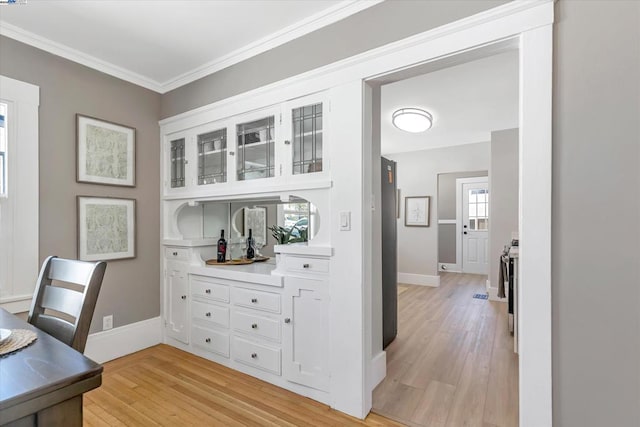 office featuring ornamental molding, light hardwood / wood-style floors, and a wealth of natural light