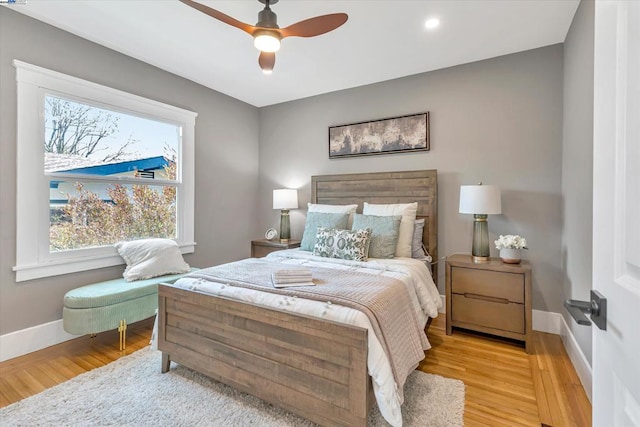 bedroom with ceiling fan and light hardwood / wood-style flooring