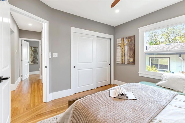 bedroom featuring hardwood / wood-style floors, a closet, and ceiling fan