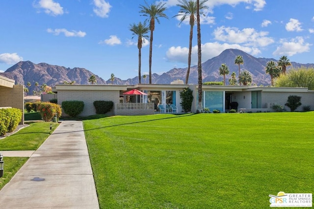 ranch-style house with a front lawn and a mountain view