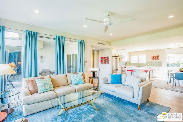 tiled living room with ceiling fan