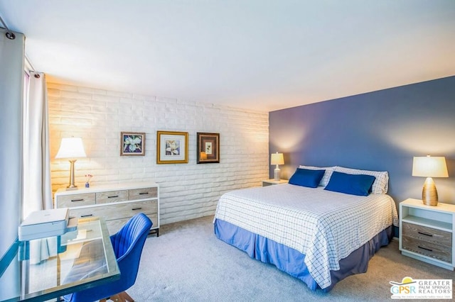 bedroom with light colored carpet and brick wall