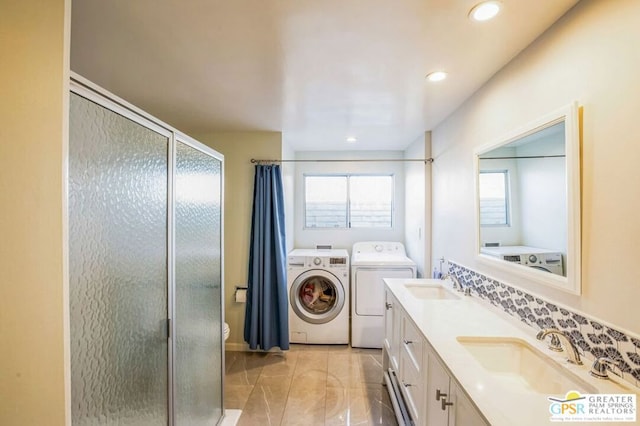 bathroom featuring toilet, a shower with door, tile patterned floors, washer and dryer, and vanity