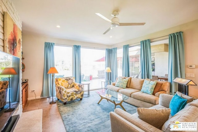 tiled living room with ceiling fan and plenty of natural light