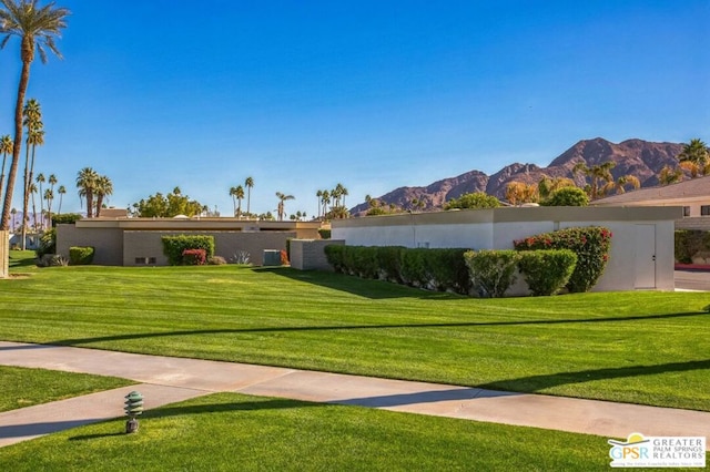 view of home's community with a lawn and a mountain view