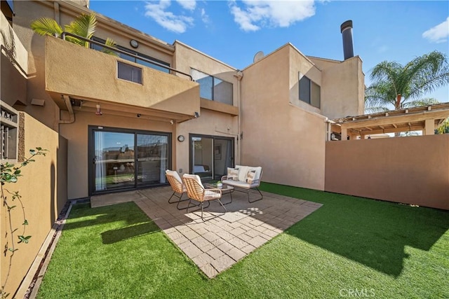 rear view of house with a patio and a lawn