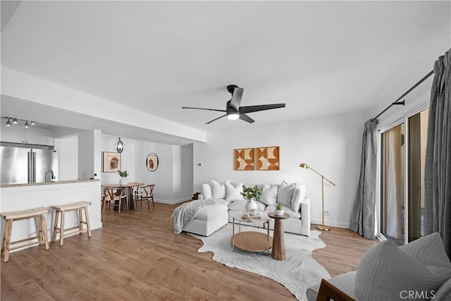 living room featuring hardwood / wood-style flooring and ceiling fan