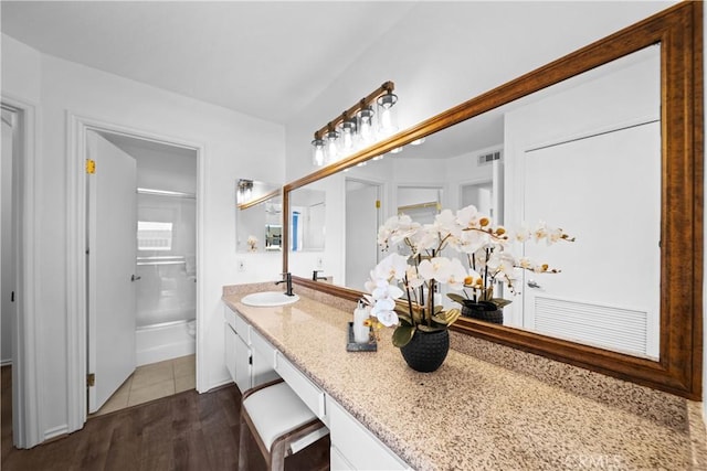 bathroom featuring vanity, hardwood / wood-style floors, and a shower