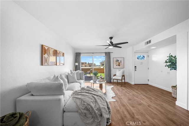 living room featuring ceiling fan and wood-type flooring