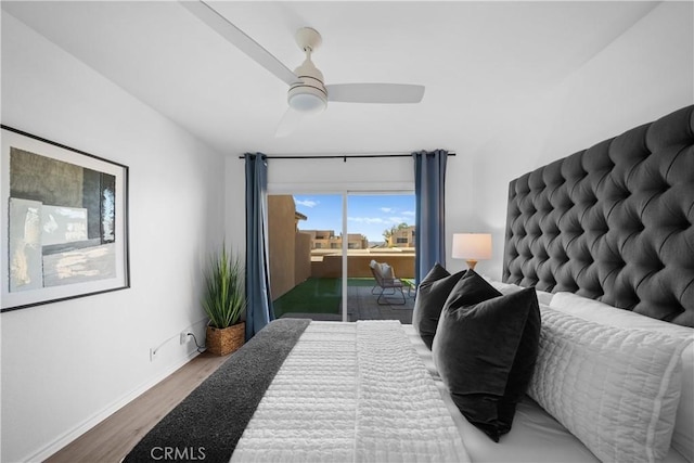 bedroom featuring dark hardwood / wood-style floors, ceiling fan, and access to exterior