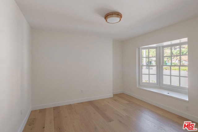 spare room featuring light hardwood / wood-style floors