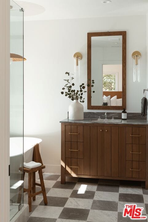 bathroom with a bathing tub and vanity