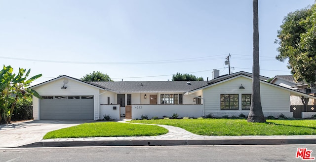 single story home featuring a front yard and a garage