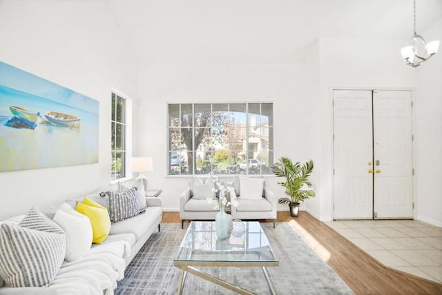 living room featuring tile patterned floors and a notable chandelier