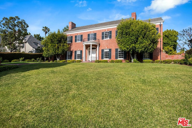 colonial house featuring a front yard