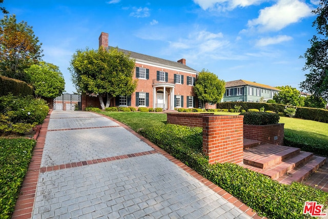 colonial inspired home with a front yard