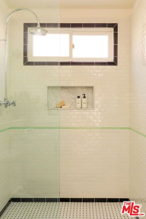 bathroom with a tile shower