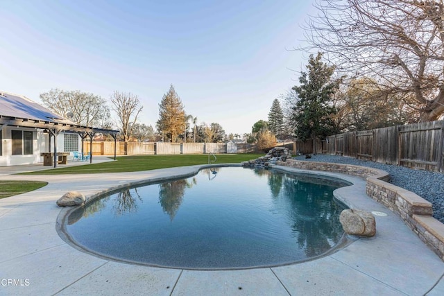 view of swimming pool with a yard and a patio