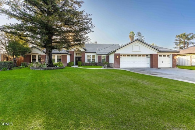 ranch-style home featuring a front lawn and a garage