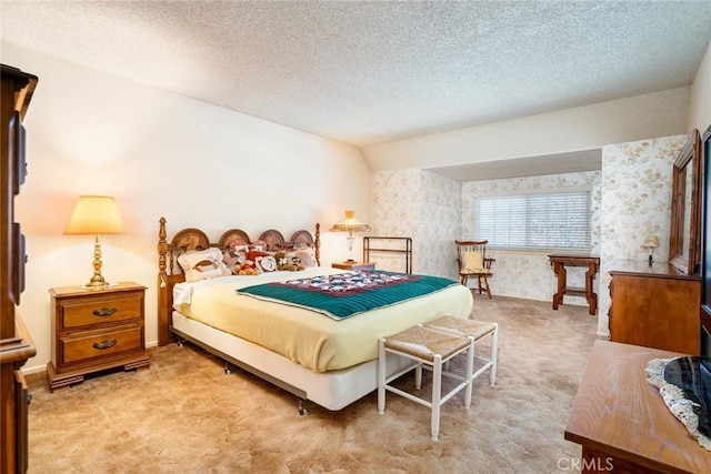 carpeted bedroom with lofted ceiling and a textured ceiling