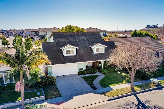 view of front of property with a front lawn and a garage