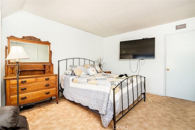 bedroom featuring light colored carpet and vaulted ceiling