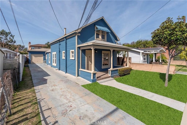 view of front facade featuring a garage, a front yard, and covered porch