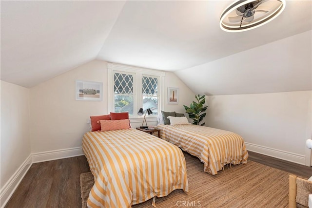 bedroom with vaulted ceiling and dark hardwood / wood-style floors