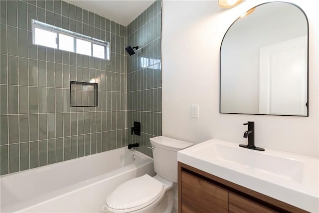 full bathroom featuring tiled shower / bath, vanity, and toilet