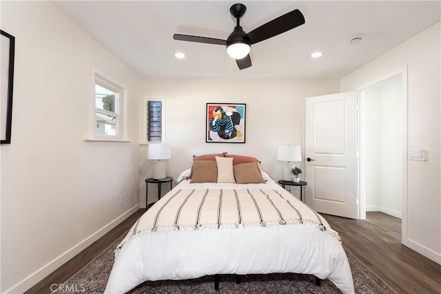 bedroom with dark hardwood / wood-style floors and ceiling fan