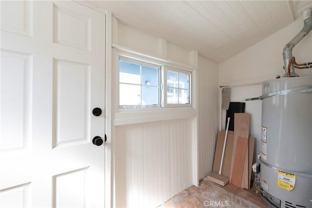 interior space featuring lofted ceiling and water heater