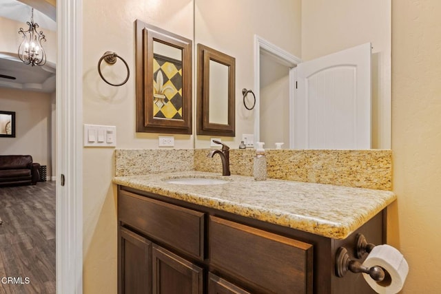 bathroom featuring vanity, a chandelier, and hardwood / wood-style flooring