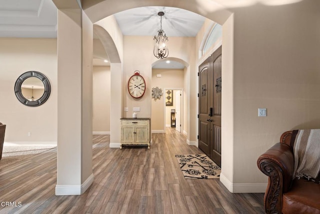 interior space with a notable chandelier and dark wood-type flooring