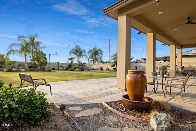 view of patio / terrace with ceiling fan and a grill