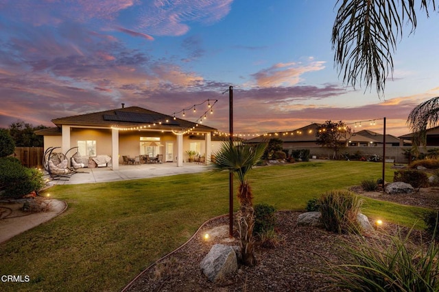 yard at dusk featuring a patio area