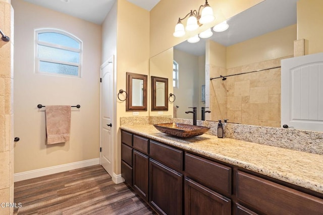 bathroom featuring vanity, hardwood / wood-style flooring, and a notable chandelier