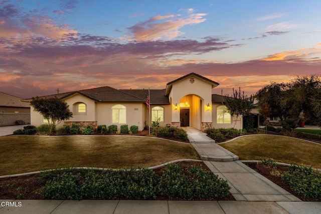 mediterranean / spanish house with a lawn