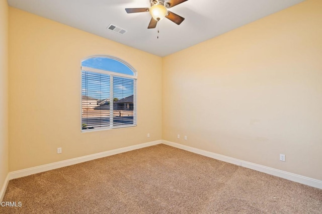 carpeted empty room featuring ceiling fan