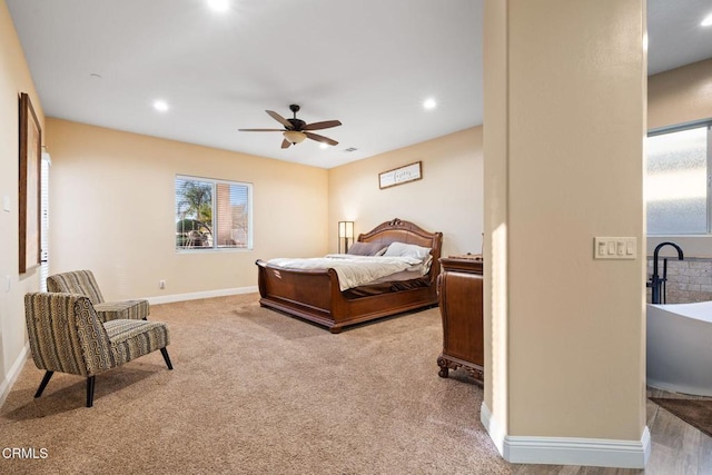 bedroom with ceiling fan and light carpet