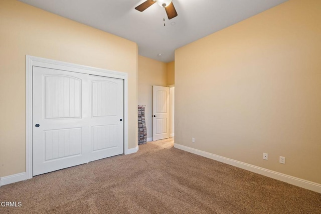 unfurnished bedroom with ceiling fan, a closet, and carpet flooring