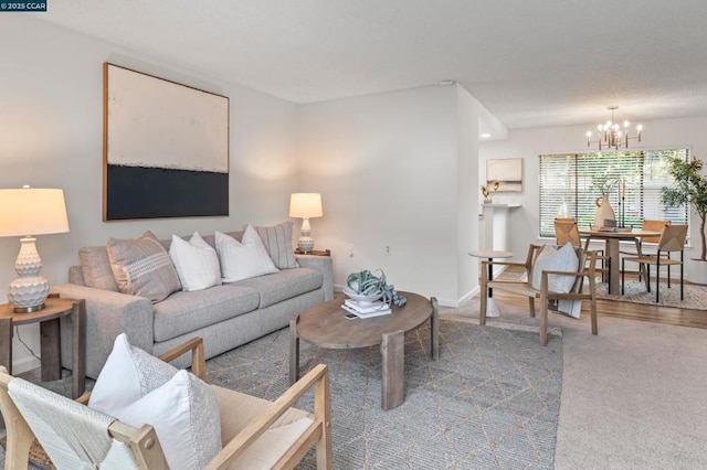 carpeted living room with a notable chandelier