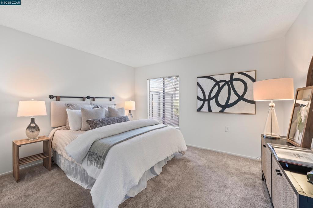 carpeted bedroom featuring a textured ceiling