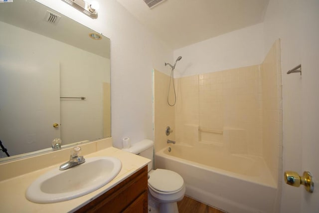 full bathroom with shower / bathtub combination, hardwood / wood-style floors, vanity, and toilet