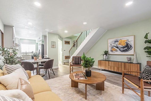 living room featuring light hardwood / wood-style floors and sink