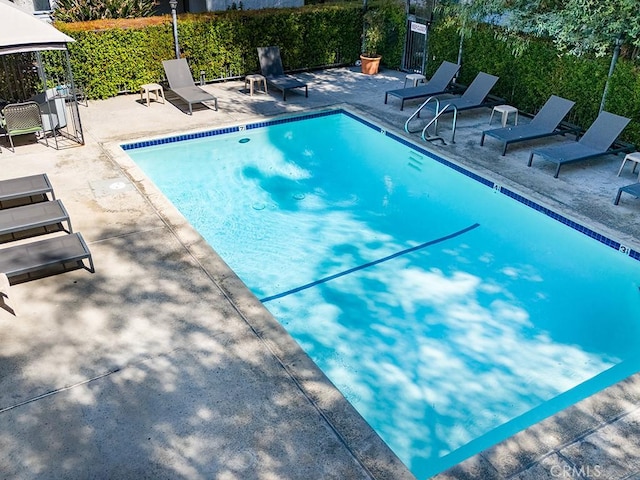 view of swimming pool featuring a patio