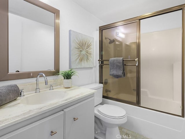 full bathroom with vanity, combined bath / shower with glass door, and toilet