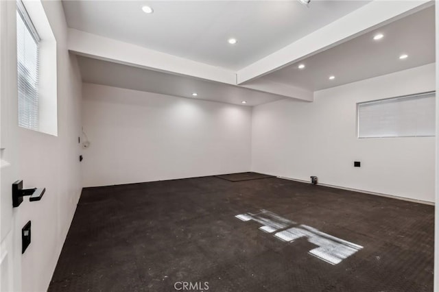 empty room featuring beam ceiling