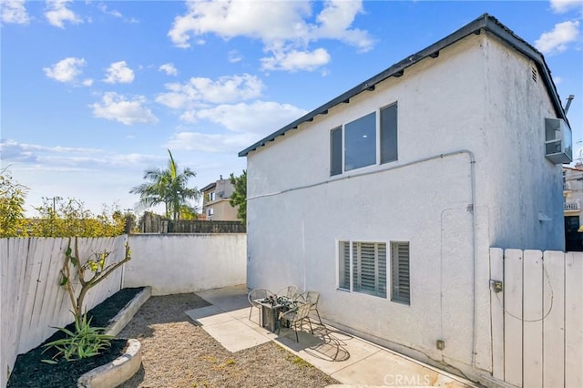 view of property exterior with a patio